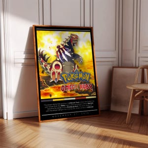 Op de afbeelding: Een poster voor de Pokemon Omega Ruby videogame. De poster heeft een vurige achtergrond met een groot, rood, zwart en wit Pokemon in het midden. De naam van de Pokemon, "Pokemon Omega Ruby", staat in grote witte letters onderaan de poster. De tekst "November 21, 2014" staat in kleinere witte letters onderaan de poster.