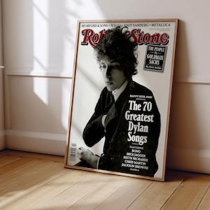 May include: A black and white photo of Bob Dylan on the cover of Rolling Stone magazine. The headline reads "The 70 Greatest Dylan Songs".