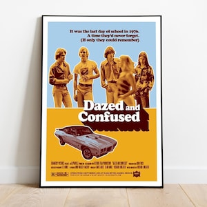 May include: A framed poster for the film "Dazed and Confused" featuring a group of young people and a classic car. The poster has a blue and yellow background with the film's title in large, bold letters. Text at the top reads "It was the last day of school in 1976."