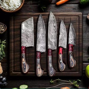May include: A set of five Damascus steel kitchen knives with patterned blades and red and brown wooden handles. The knives are arranged on a dark wooden cutting board, showcasing their sharp edges and intricate designs. A culinary set for the home chef.