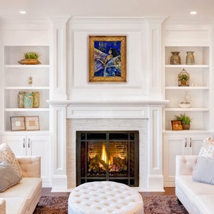 May include: A white fireplace with a brick interior and a fire burning. The fireplace is surrounded by white built-in shelves with decorative items. A framed painting of a woman with a blue background hangs above the fireplace.