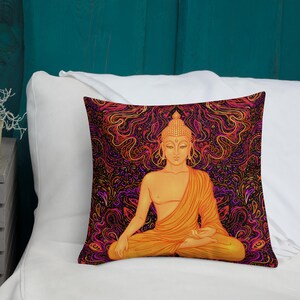 May include: Square pillow featuring a seated Buddha illustration. The Buddha is depicted in shades of orange and gold, set against a vibrant, swirling background of red, purple, and black. The pillow is placed on a white surface.