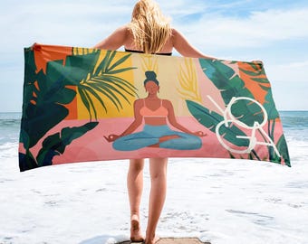 May include: A beach towel with a colorful design featuring a woman meditating in a yoga pose surrounded by tropical leaves and flowers. The towel has the word "yoga" written on it.