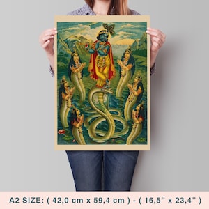 May include: A vintage-style print featuring a deity in blue playing a flute, standing on a cobra, surrounded by figures with serpent bodies. The artwork has a yellow and green color palette, with a mountain backdrop. The print measures 16.5" x 23.4".