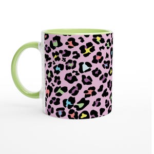 May include: A pink ceramic mug with a green rim and a colorful leopard print design.