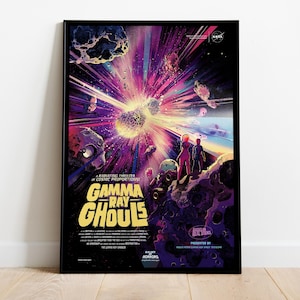 May include: A framed poster with a retro sci-fi illustration. The artwork features a cosmic explosion with the text "Gamma Ray Ghouls." The colour palette includes purple, pink, and yellow hues, with figures in space suits. The NASA logo is visible.
