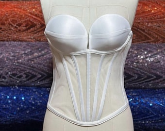 May include: White mesh corset with boning and a satin bust. The corset is on a white mannequin.