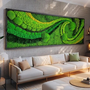 May include: A framed moss wall art piece with a green and yellow design. The moss is arranged in a swirling pattern, creating a natural and organic look. The piece is hanging on a white wall above a white sofa.