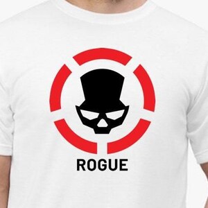 May include: White t-shirt with a red circle and black skull graphic. The skull is wearing a top hat. The text "ROGUE" is below the graphic.