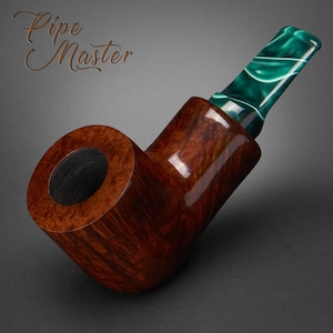 May include: A handcrafted tobacco pipe with a polished, dark brown wooden bowl and stem. The mouthpiece is a vibrant green and white marbled design. The text "Pipe Master" is in the upper left corner.