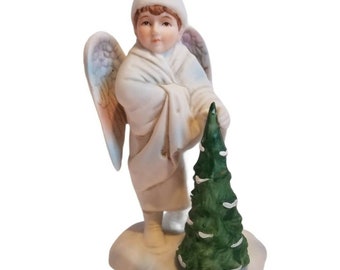 Vintage 1986 Enesco Porcelain Ceramic Child Angel standing over Evergreen Tree