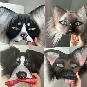 May include: Four animal masks: a black and white cat, a Siamese cat, a black and white dog, and a brown dog. Each mask has detailed features, including eyes, noses, and fur. The dog masks have tongues. The cat masks have pointed ears.