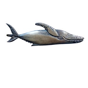 May include: A wooden whale sculpture with a detailed design. The whale is painted in a brown and gray color scheme.