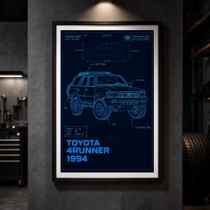 May include: A framed blueprint poster featuring a 1994 Toyota 4Runner in blue line art on a dark background. The print includes technical specifications, a side profile view, and the text Toyota 4Runner 1994. The dimensions shown are 66.1 in height and 176.8 in length.