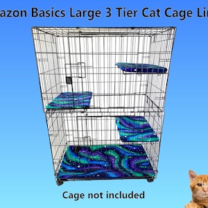 May include: Three-tiered cat cage liners with a galaxy print in shades of blue, green, and purple. The liners are made of soft fabric and are designed to fit a large cat cage. Cage not included.
