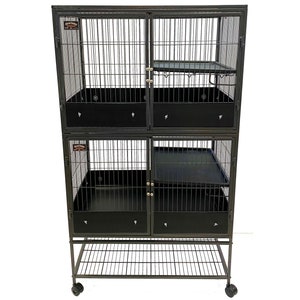 May include: Black metal cage with two levels and a bottom shelf. The cage has a black plastic tray and a metal ramp. The cage is on wheels.