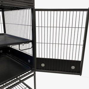 May include: Black metal cage with multiple levels and pull-out trays. The cage has a door that is open.