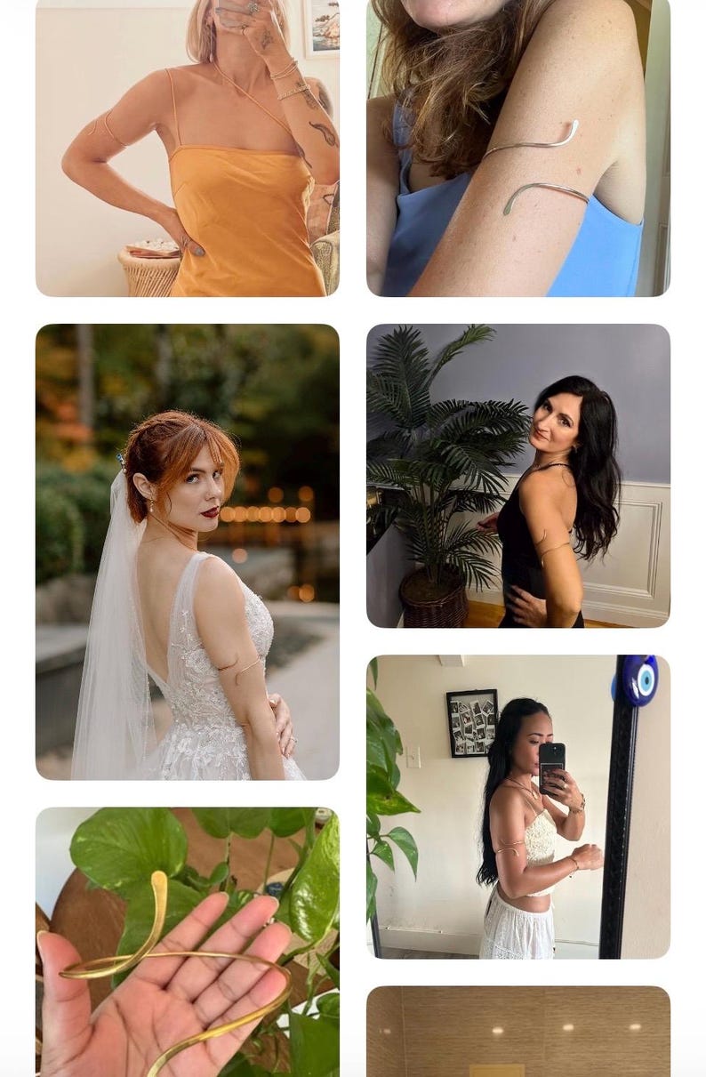 May include: A gold-toned metal arm cuff featuring a sleek, open-ended spiral design that wraps around the upper arm. The accessory has a smooth, polished finish and a flexible, adjustable band structure that maintains its shape when worn.