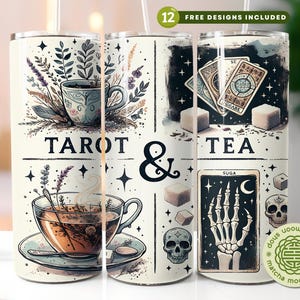 May include: A white tumbler featuring tarot card and tea-themed illustrations. The design includes images of teacups, tarot cards, sugar cubes, and a skeleton hand. The words "TAROT & TEA" are prominently displayed.