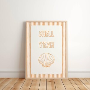 May include: A white printable art print with orange stripes on the border. The print features the text "Shell Yeah" and a line drawing of a seashell.
