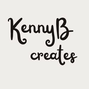 May include: A graphic design featuring the black text KennyB creates in a stylized, cursive script font against a solid, light beige background. The lettering is bold and clear, with the word KennyB positioned above the word creates.