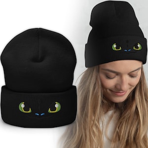 May include: Black beanie with a green and blue embroidered dragon face on the front.