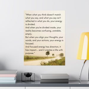 May include: A poster with text: "When what you think doesn't match what you say... your energy is divided... But when you align your thoughts... your energy is focused." The background shows a road with trees.