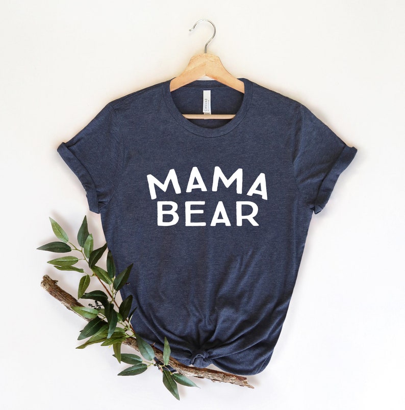 May include: A dark blue t-shirt with the text "MAMA BEAR" printed in white on the front.