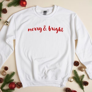 May include: White Christmas sweatshirt with red lettering that says "merry & bright".