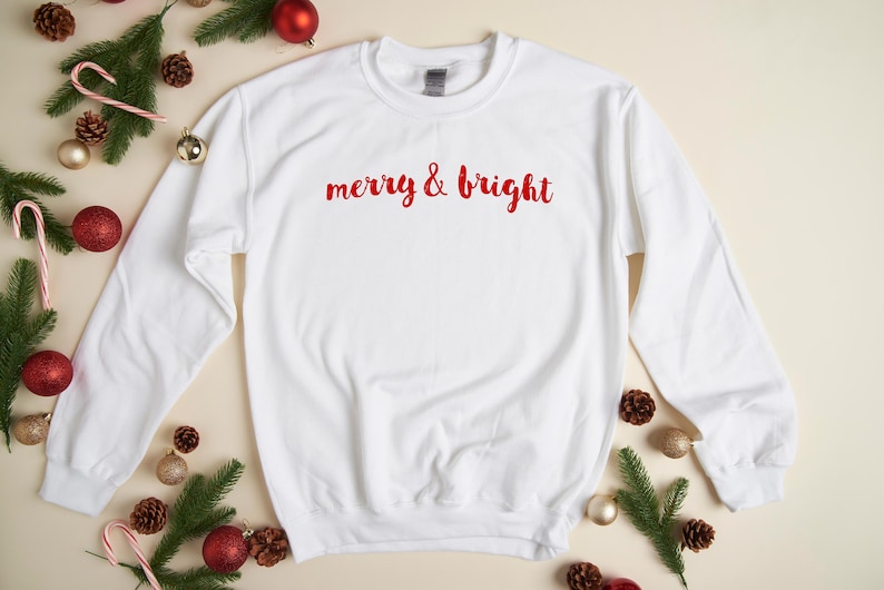 May include: White Christmas sweatshirt with red lettering that says "merry & bright".