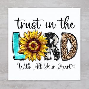 May include: A white background with the text "Trust in the LORD with all your heart" in black. The word "LORD" is in large letters with a sunflower in the middle of the "O" and different patterns on the other letters.