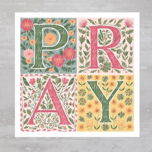 May include: A floral print art print with the word "PRAY" in large letters. Each letter is surrounded by a different floral pattern in shades of pink, green, and yellow.