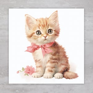 May include: A cute orange tabby kitten wearing a pink bow sits on a white background. The kitten has green eyes and a pink nose. A pink flower is in the background.