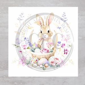 May include: A watercolor illustration of a brown bunny rabbit sitting in a basket filled with pastel colored Easter eggs and pink flowers. The bunny is wearing a pink ribbon around its neck.