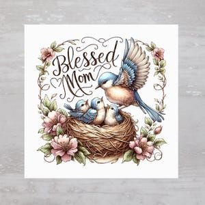 May include: A bluebird with three baby birds in a nest surrounded by pink flowers. The text "Blessed Mom" is written in cursive above the nest.