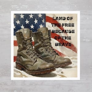 May include: A pair of brown leather military boots with camouflage print on the sides, resting on a red, white, and blue American flag. The text "LAND OF THE FREE BECAUSE OF THE BRAVE" is printed in black on a white background.
