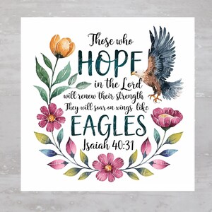 May include: A white background with a watercolour floral wreath surrounding a quote from Isaiah 40:31. The quote reads "Those who hope in the Lord will renew their strength. They will soar on wings like eagles."