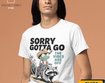 Funny Cowboy Frog T-Shirt: Raccoon Rider Graphic Tee