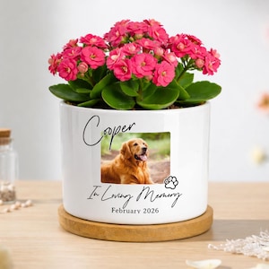 May include: A white ceramic mug with a black handle and the text "But First, Coffee" in a handwritten style. The mug is on a white surface. The mug is approximately 4 inches tall.