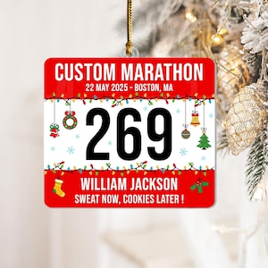 May include: A red and white custom marathon ornament. It features the text "CUSTOM MARATHON", "22 MAY 2025 - BOSTON, MA", and the number "269". The ornament also includes the name "WILLIAM JACKSON" and the phrase "SWEAT NOW, COOKIES LATER!".