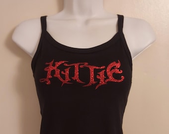 May include: A black tank top with red glitter lettering that says "KUTIE".