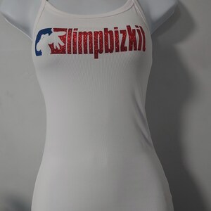 May include: White tank top with a red and blue graphic that says "limpbizkit" in red glitter.