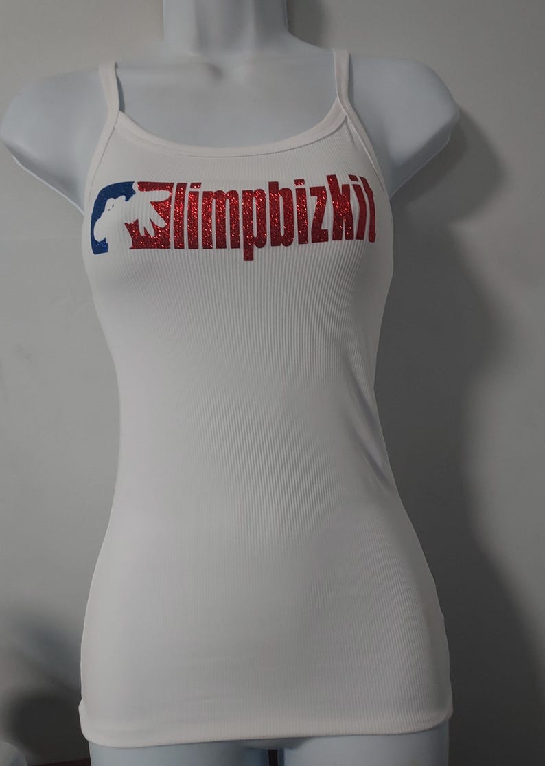 May include: White tank top with a red and blue graphic that says "limpbizkit" in red glitter.