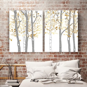 May include: Two-panel wall art featuring stylized birch trees with gray trunks and gold-colored leaves against a white background. The artwork is displayed above a bed made from wooden pallets with white bedding.