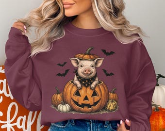 ハロウィンのブタのスウェットシャツ、かぼちゃの中の不気味でかわいい子ブタのプルオーバー、ヴィンテージ風の秋のクルーネック、農場の動物のかぼちゃ畑のトップス、ハロウィンシーズンのギフト