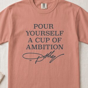 Coral t-shirt with text "Pour Yourself a Cup of Ambition Dolly"