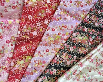 May include: A collection of colorful floral patterned fabrics. The fabrics feature a variety of colors, including pink, red, purple, black, and white. The floral patterns include cherry blossoms and other decorative elements.