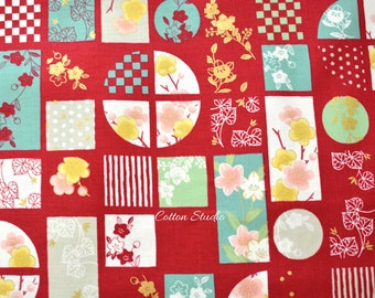 May include: Red fabric with a repeating pattern of geometric shapes and floral designs in shades of green, white, and gold. The fabric features a variety of shapes, including squares, circles, and half circles. The floral designs are stylized and feature delicate branches with small flowers.