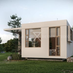 May include: A modern, white, minimalist building with large windows and a flat roof. The building is surrounded by green grass and trees. The text "AMP DESIGN STUDIO" is visible on the building.