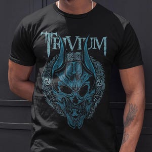 May include: A black t-shirt with a blue and white graphic of a skull with horns and the word "TRIVIUM" above it.